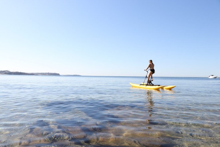 a man on a surf board on a body of water