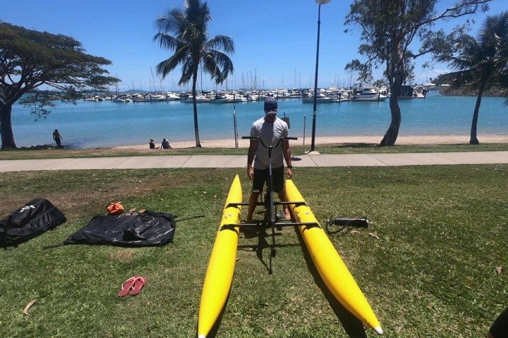 a group of people on a beach near a body of water